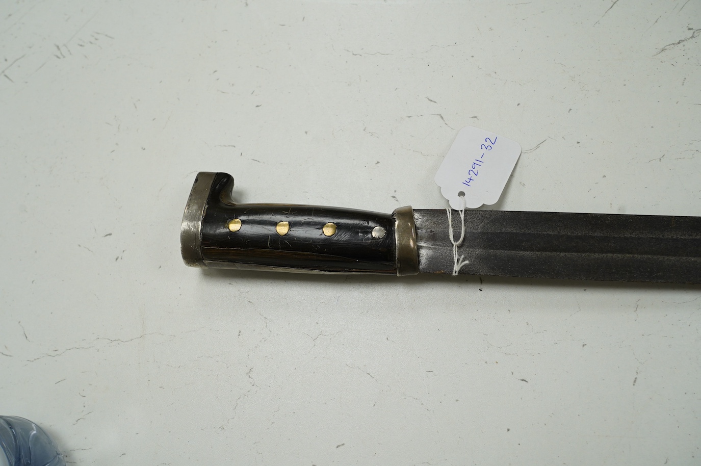 A Mexican sword machete, broad blade cut with a single fuller, with silver mounted horn hilt, blade 81cm. Condition - good